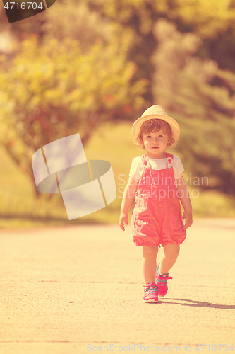 Image of little girl runing in the summer Park