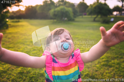 Image of little girl spending time at backyard