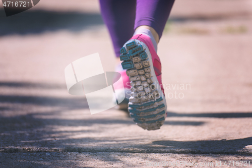 Image of young female runner training for marathon