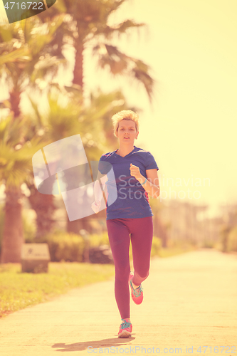 Image of young female runner training for marathon