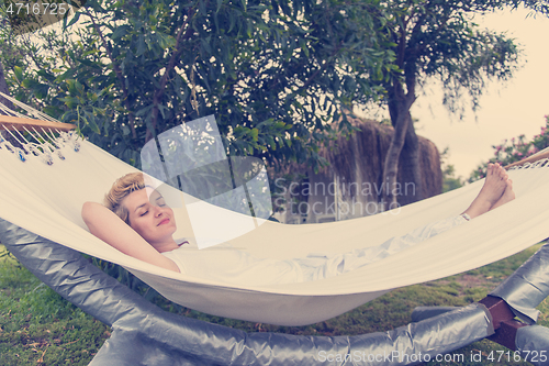 Image of young woman resting on hammock