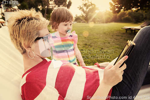 Image of mom and a little daughter relaxing in a hammock