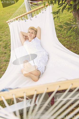 Image of young woman resting on hammock