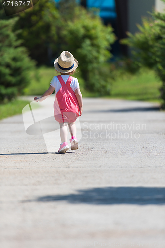 Image of little girl runing in the summer Park