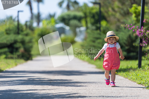 Image of little girl runing in the summer Park