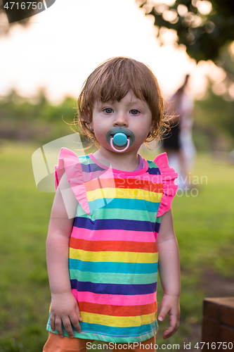 Image of little girl spending time at backyard