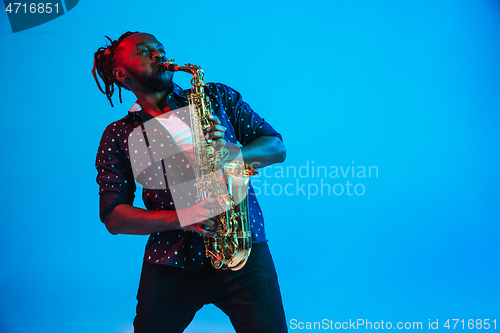 Image of Young african-american jazz musician playing the saxophone