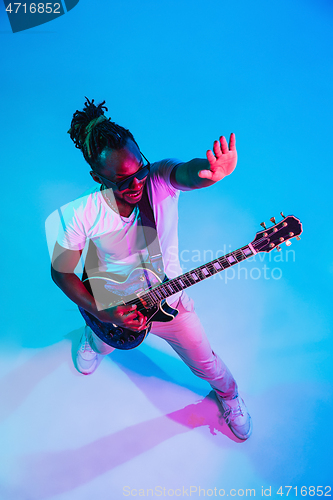 Image of Young african-american jazz musician playing the guitar