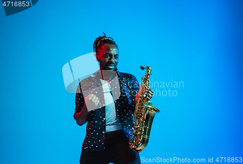 Image of Young african-american jazz musician playing the saxophone