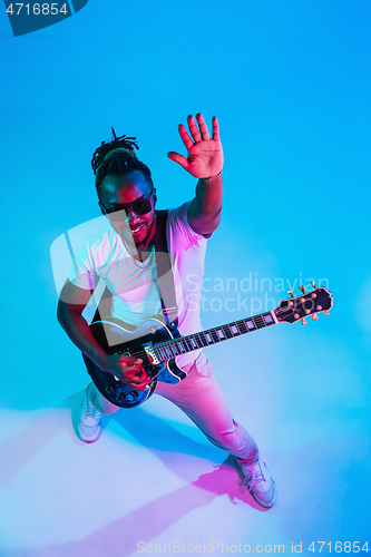 Image of Young african-american jazz musician playing the guitar