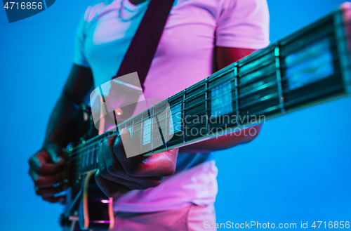 Image of Young african-american jazz musician playing the guitar