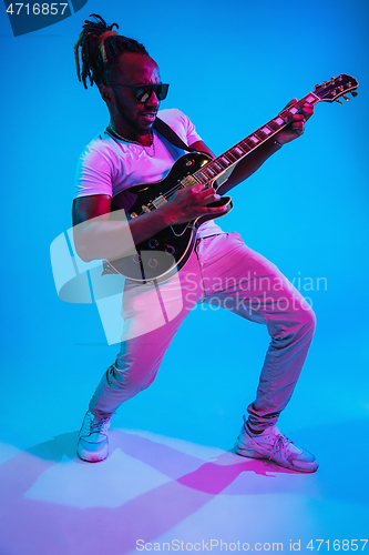 Image of Young african-american jazz musician playing the guitar