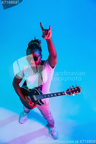 Image of Young african-american jazz musician playing the guitar