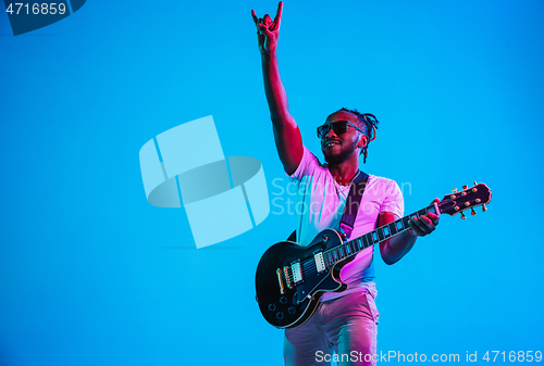 Image of Young african-american jazz musician playing the guitar