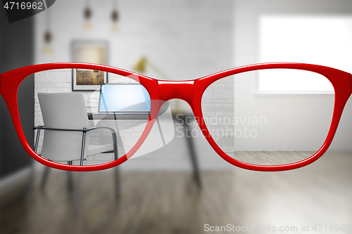 Image of red glasses with home office sharp and blurred