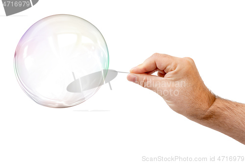 Image of soap bubble and a males hand with needle to let it pop