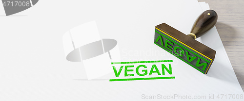 Image of green stamp vegan on white paper background