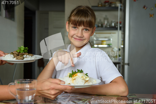 Image of Happy girl chose one dish out of two offered by her mother for lunch