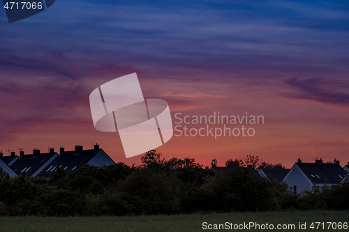 Image of Houses and trees at sunset