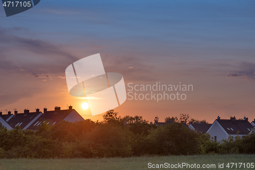 Image of Houses and trees at sunset