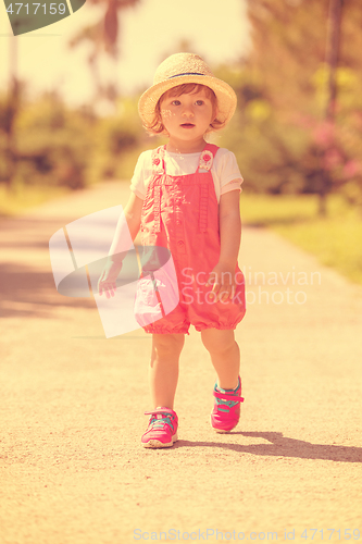 Image of little girl runing in the summer Park