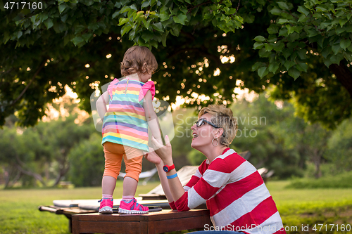 Image of mom and her little daughter using tablet computer