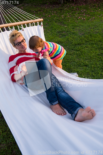 Image of mom and a little daughter relaxing in a hammock