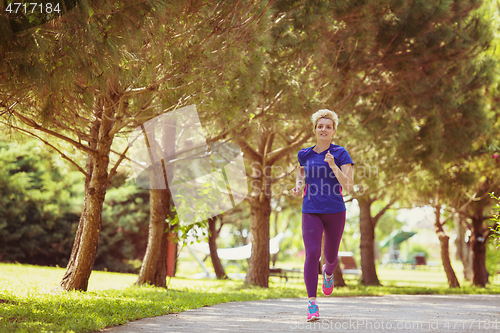 Image of young female runner training for marathon