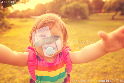 Image of little girl spending time at backyard