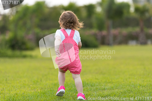 Image of little girl spending time at backyard