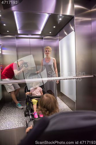 Image of happy family in the elevator