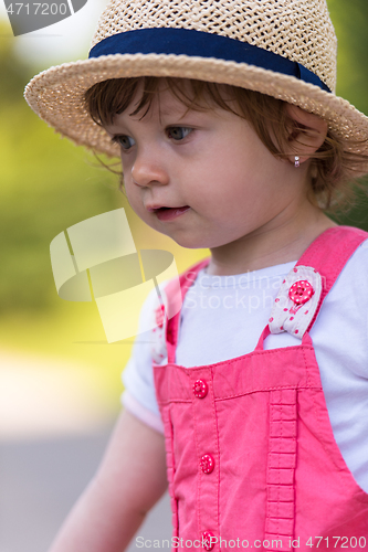 Image of little girl runing in the summer Park