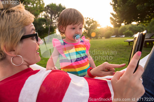 Image of mom and a little daughter relaxing in a hammock