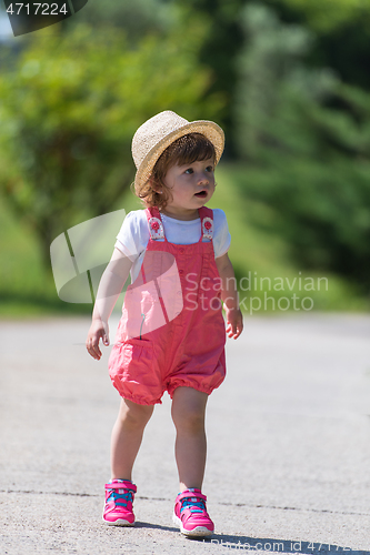 Image of little girl runing in the summer Park