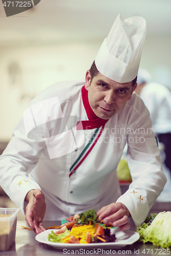 Image of chef serving vegetable salad