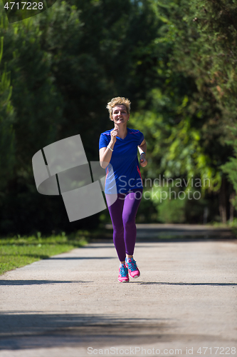 Image of young female runner training for marathon