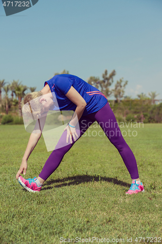 Image of female runner warming up and stretching