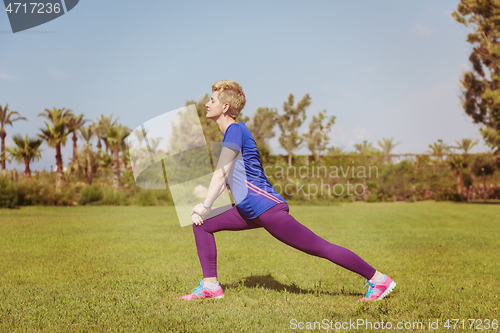 Image of female runner warming up and stretching