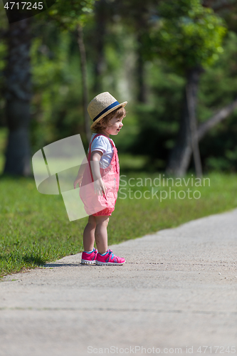 Image of little girl runing in the summer Park