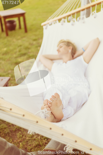 Image of young woman resting on hammock