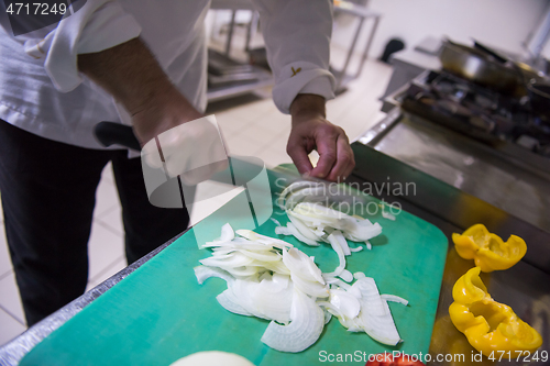 Image of Chef hands cutting fresh and delicious vegetables