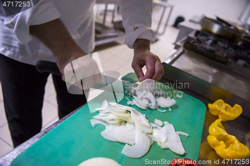 Image of Chef hands cutting fresh and delicious vegetables