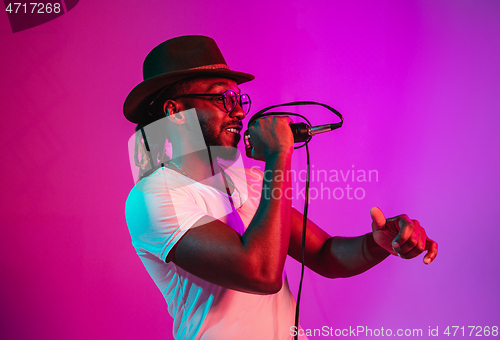 Image of Young african-american jazz musician singing a song