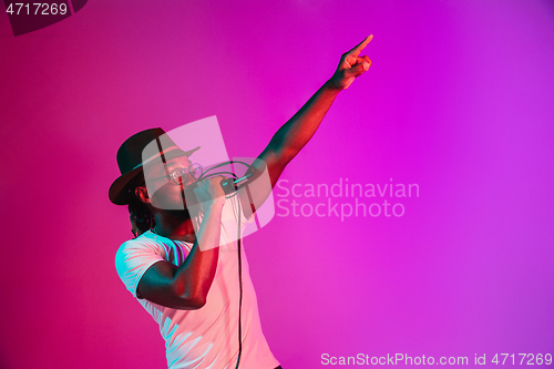 Image of Young african-american jazz musician singing a song