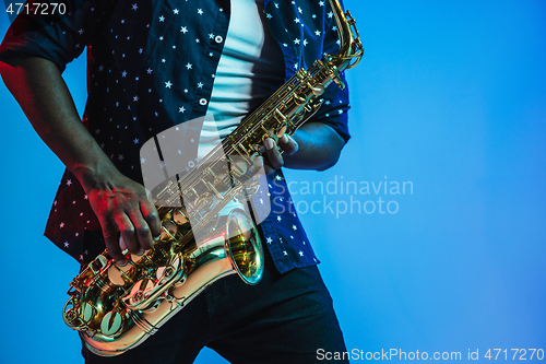 Image of Young african-american jazz musician playing the saxophone