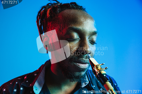 Image of Young african-american jazz musician playing the saxophone