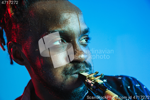 Image of Young african-american jazz musician playing the saxophone