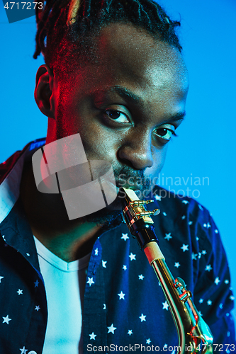 Image of Young african-american jazz musician playing the saxophone