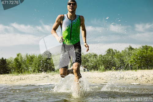 Image of Professional triathlete swimming in river\'s open water