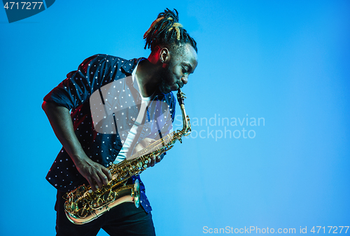 Image of Young african-american jazz musician playing the saxophone